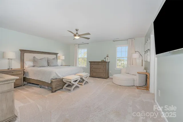 a bedroom with bed and white cabinets