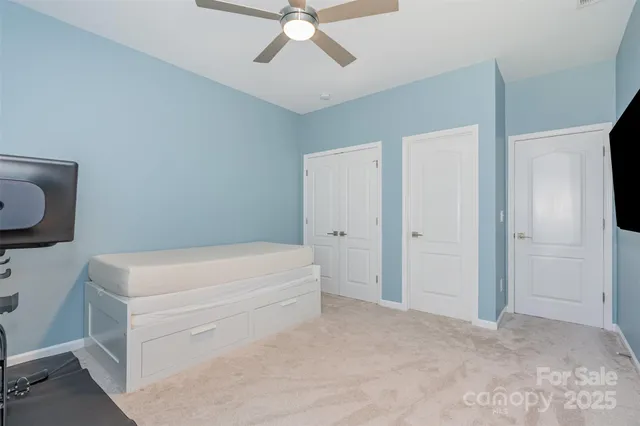 a room with a furniture and a fan