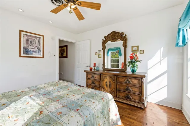 a bedroom with a bed mirror and a window