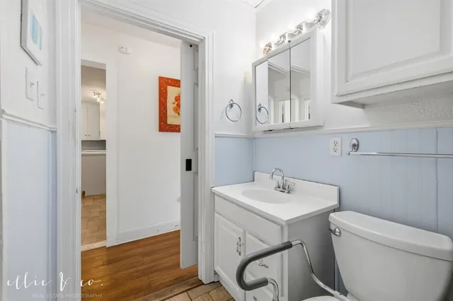 a bathroom with a sink mirror and toilet
