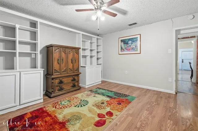a view of a workspace with furniture and wooden floor