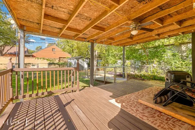 a view of a balcony with wooden floor and iron stairs
