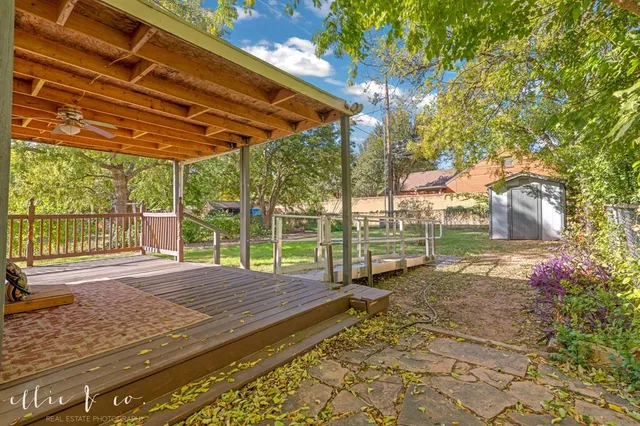 a view of a backyard with wooden fence