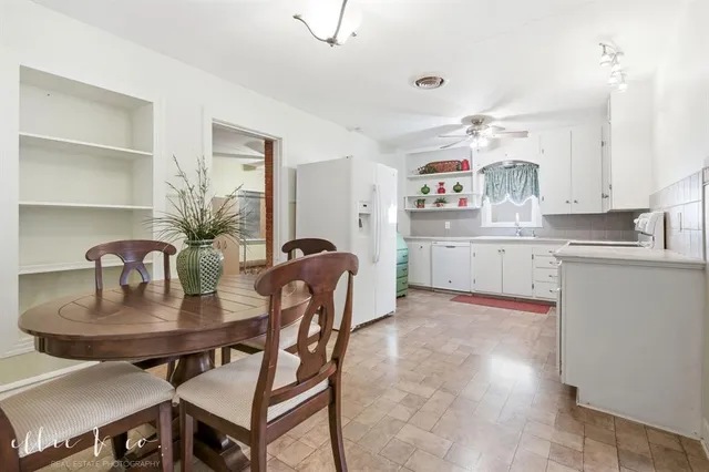a kitchen with granite countertop a table and chairs in it