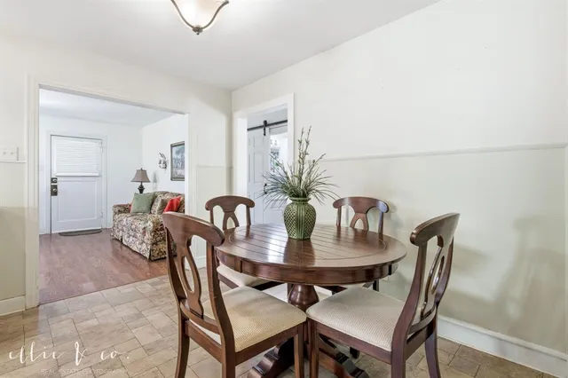 a dining room with furniture and wooden floor