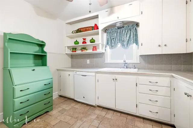 a kitchen with cabinets and window