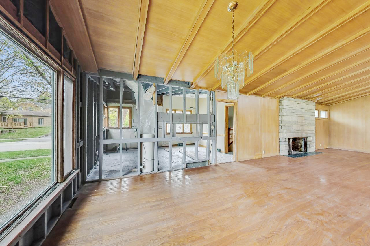 246 Miller Avenue DeKalb, IL 60115 - Photo 12 of 56 a view of empty room with wooden floor and fireplace