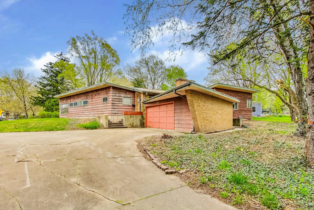 246 Miller Avenue DeKalb, IL 60115 - Photo 3 of 56 a small house with a big yard and large trees