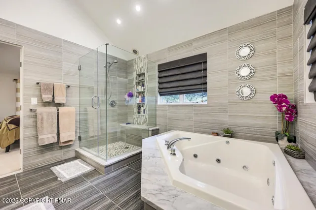 a bedroom with a bed and a large mirror