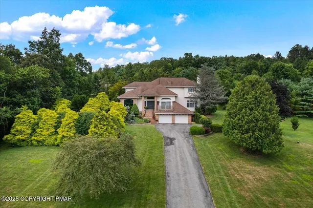 a view of a patio with chairs and a table under an umbrella