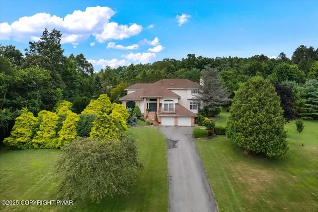 a view of a house with backyard sitting area and garden