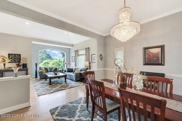 a front view of a house with a garden and plants