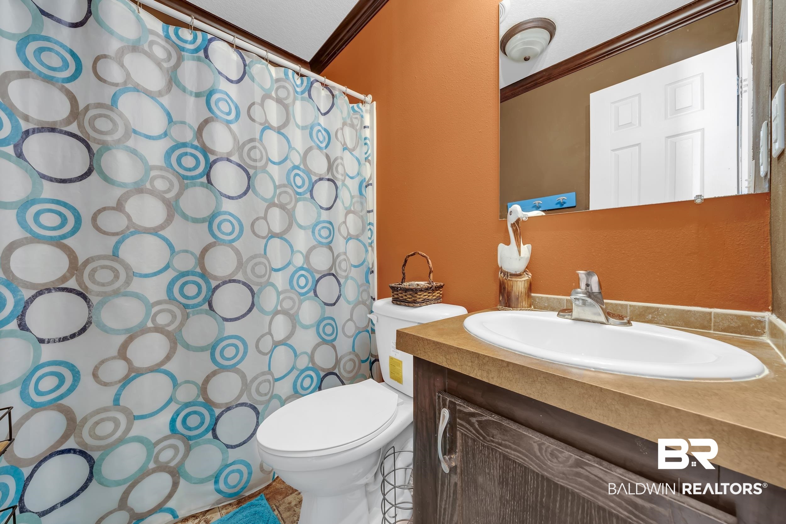 16707 Fort Morgan Road, Unit 8 Gulf Shores, AL 36542 - Photo 13 of 27 Full bath with vanity, a shower with shower curtain, and crown molding