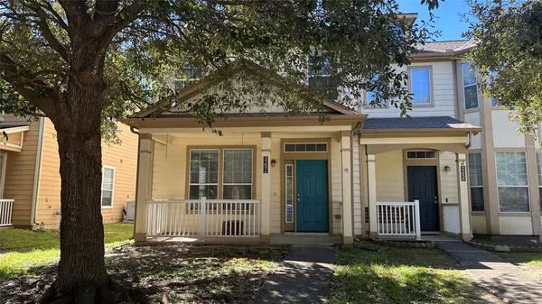 front view of a house with a large window and a yard