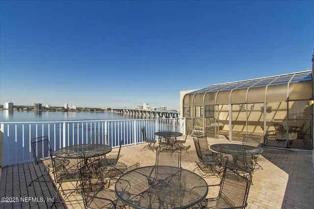 a view of a patio with a table and chairs