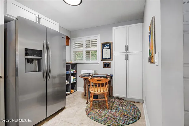 a kitchen with stainless steel appliances granite countertop a refrigerator and a stove