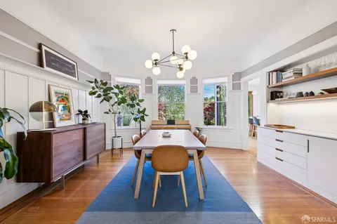a view of a dining room with furniture and wooden floor