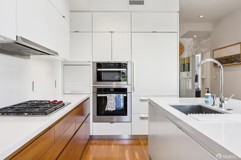 a kitchen with stainless steel appliances kitchen island a sink stove and refrigerator