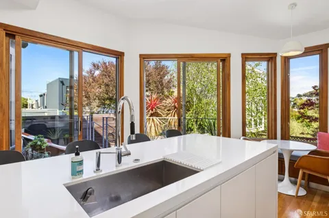 a outdoor living room with furniture and a potted plant