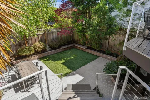 a view of deck with seating and trees