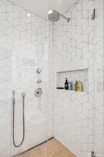 a view of a bathroom with a tub and shower