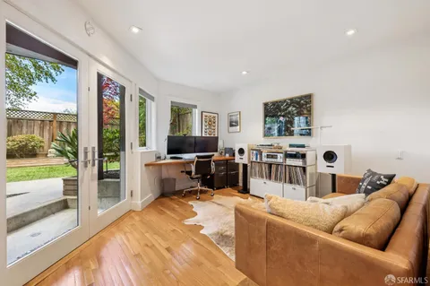 a patio with table and chairs and potted plants