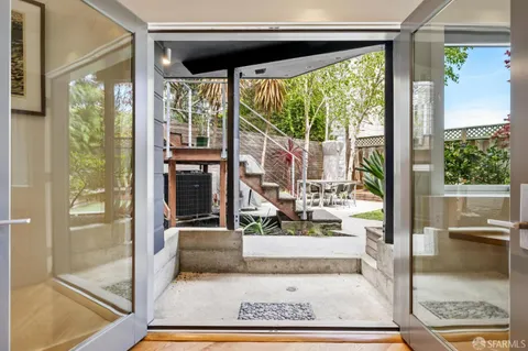 a view of patio with table and chairs and wooden fence