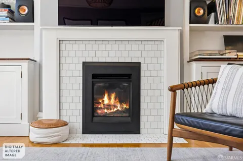 a living room with a fireplace and a flat screen tv