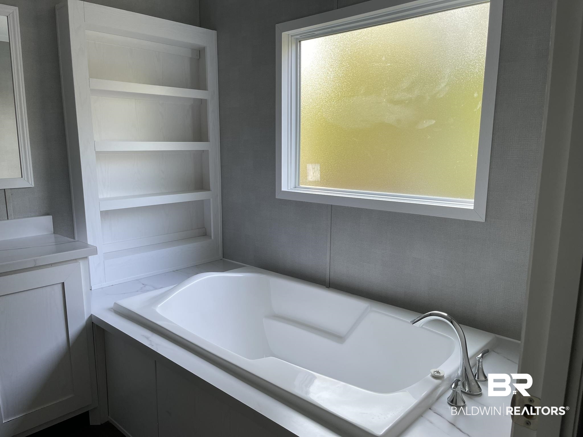 9202 Bay Pnes Road Elberta, AL 36530 - Photo 6 of 17 Bathroom with a garden tub, built in features, and vanity