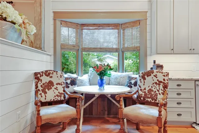 a living room with furniture and large windows