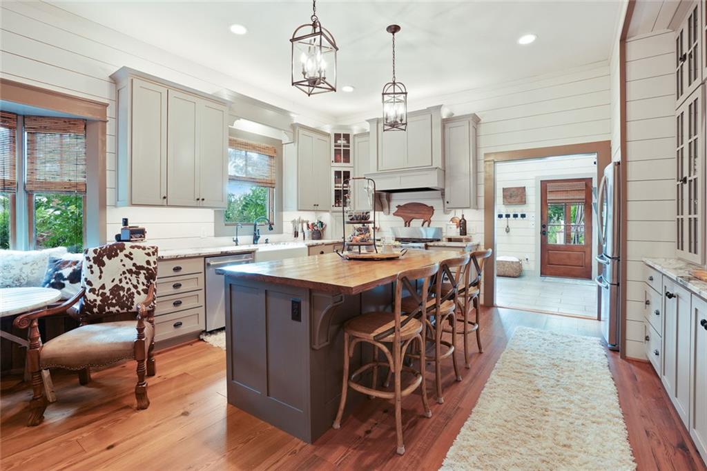 745 Washington Street Clarkesville, GA 30523 - Photo 14 of 54 a open kitchen with stainless steel appliances granite countertop a sink dishwasher a refrigerator and a dining table with wooden floor