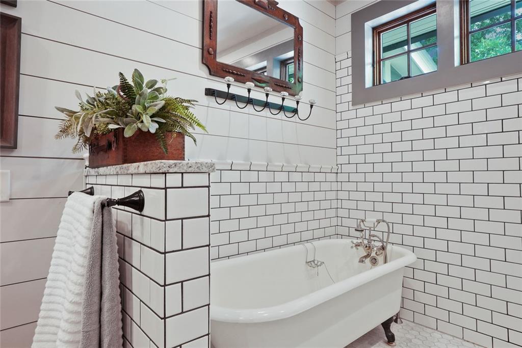 745 Washington Street Clarkesville, GA 30523 - Photo 32 of 54 a bathroom with a bathtub and a shower