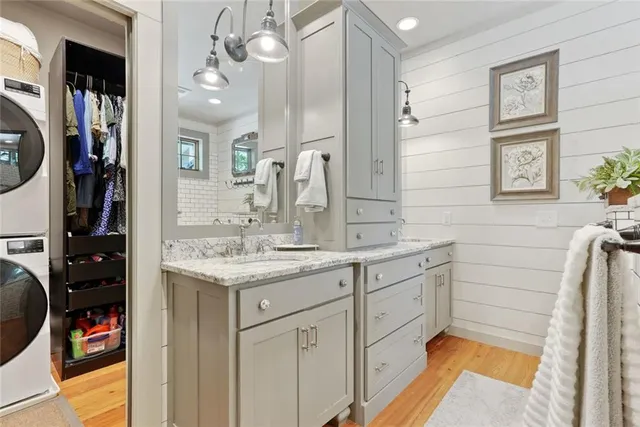 a bathroom with a granite countertop sink a toilet and a bathtub