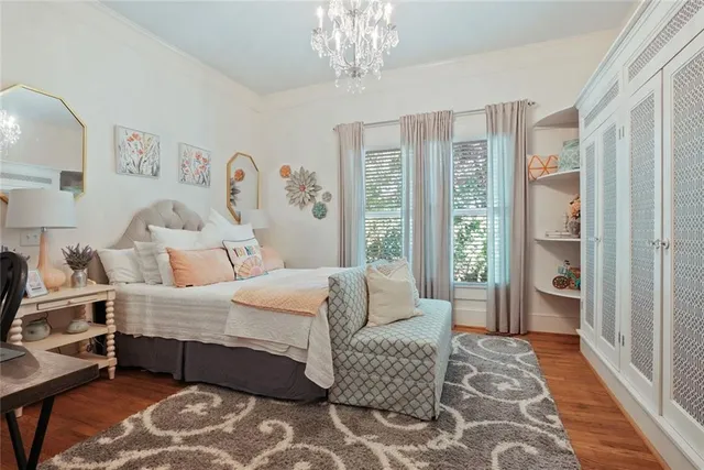 a bedroom with a bed and painting on the wall