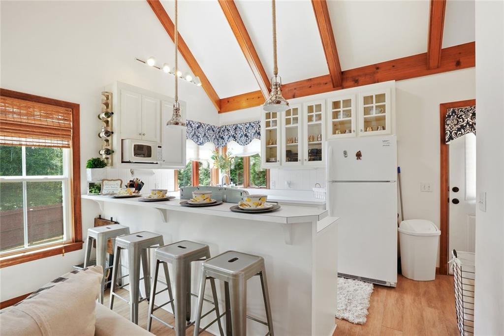745 Washington Street Clarkesville, GA 30523 - Photo 45 of 54 a kitchen with stainless steel appliances granite countertop a table chairs stove and wooden floor