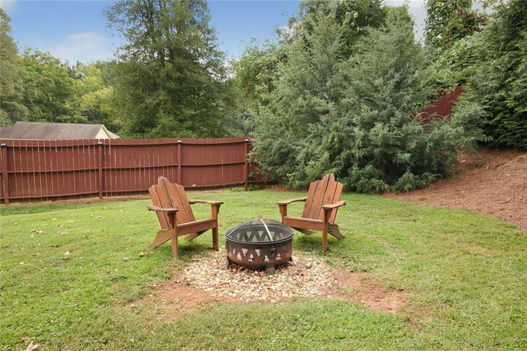 745 Washington Street Clarkesville, GA 30523 - Photo 51 of 54 a view of a backyard with lawn chairs and a fire pit