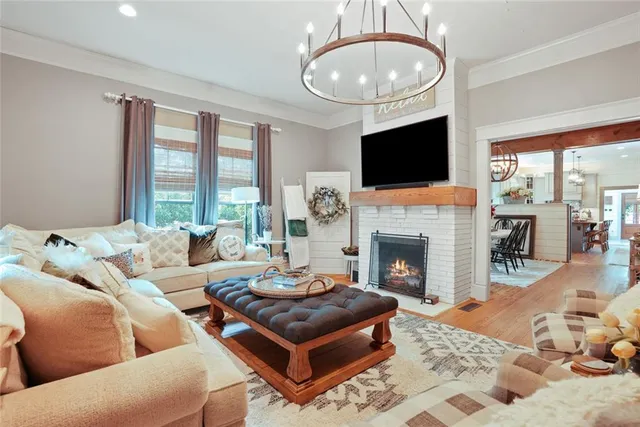 a living room with furniture a flat screen tv and a fireplace