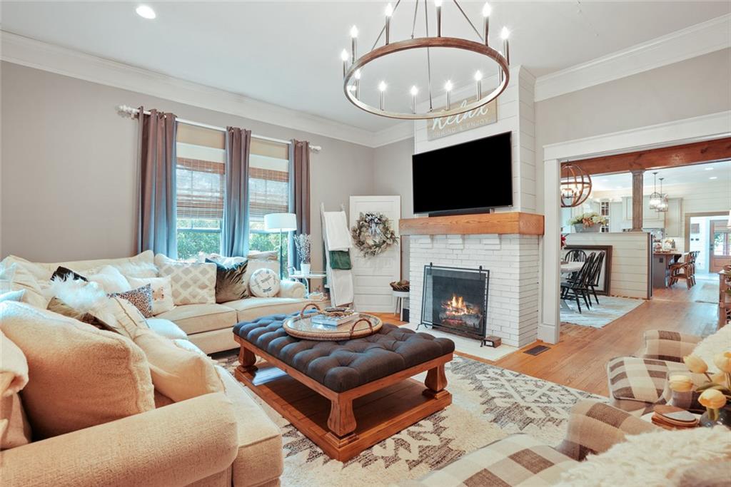 745 Washington Street Clarkesville, GA 30523 - Photo 8 of 54 a living room with furniture a flat screen tv and a fireplace