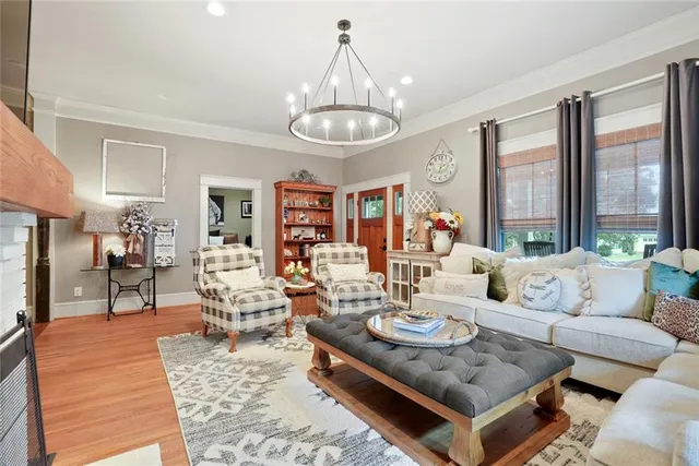 a living room with furniture a rug and a chandelier