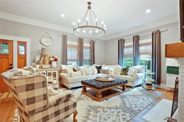 a living room with fireplace furniture and a large window