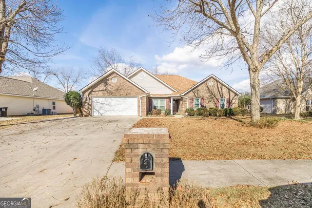 a view of house with snow on the road