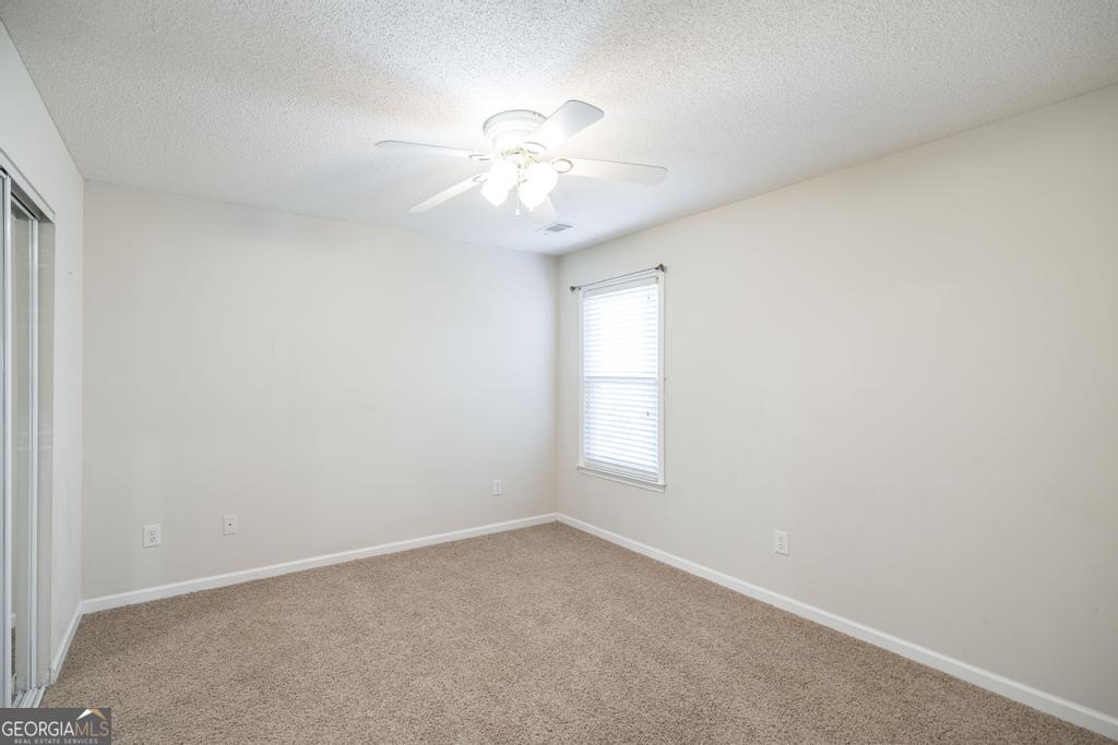 209 Mossy Ridge Warner Robins, GA 31088 - Photo 21 of 38 an empty room with windows and fan