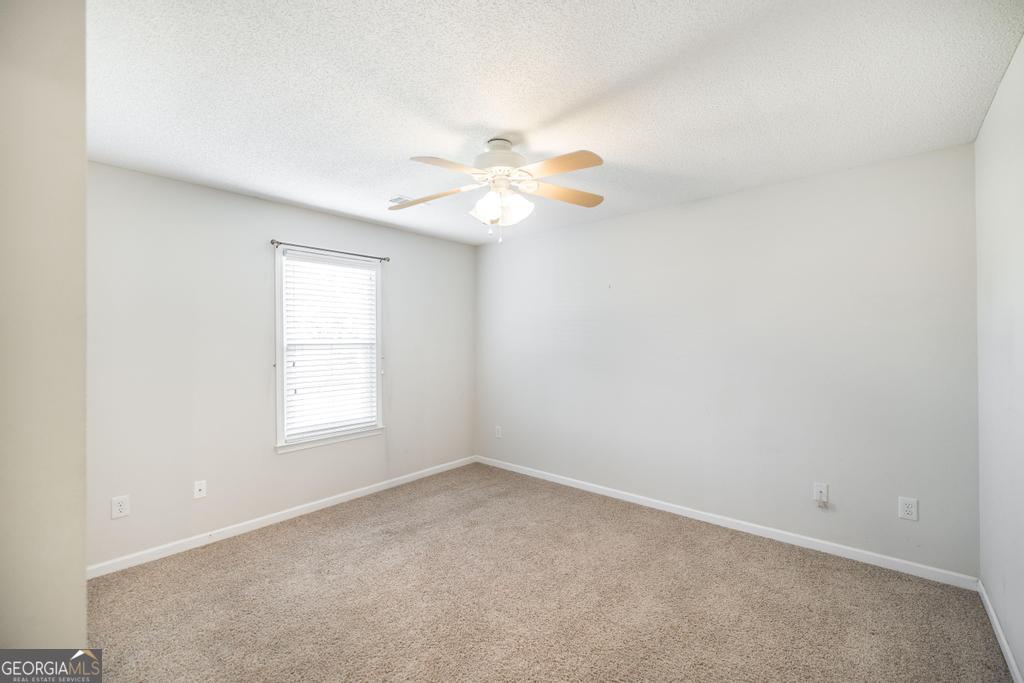 209 Mossy Ridge Warner Robins, GA 31088 - Photo 23 of 38 an empty room with a window and a fan