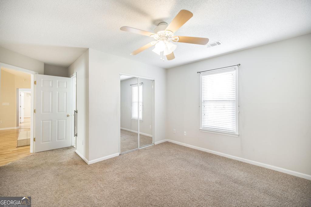 209 Mossy Ridge Warner Robins, GA 31088 - Photo 24 of 38 an empty room with windows and fan