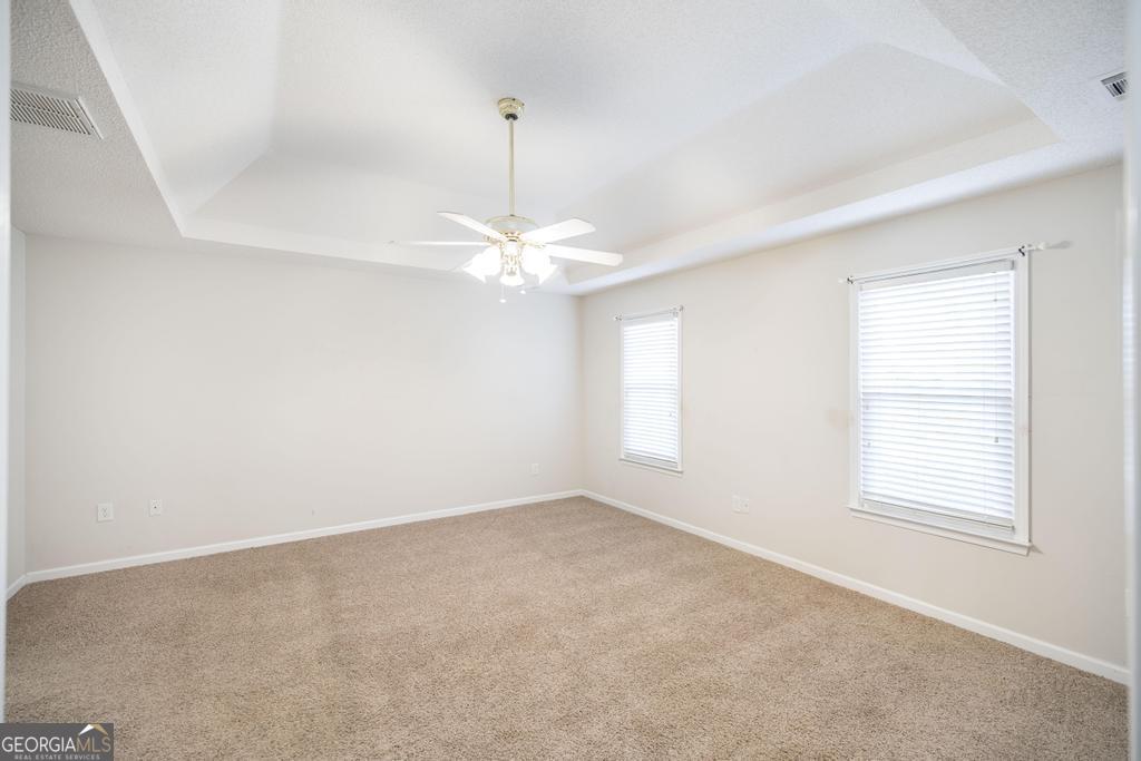 209 Mossy Ridge Warner Robins, GA 31088 - Photo 27 of 38 an empty room with a window and chandelier fan