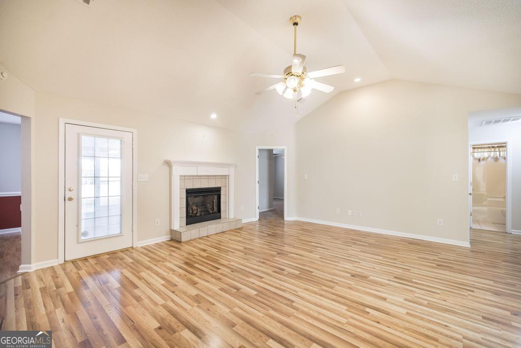 209 Mossy Ridge Warner Robins, GA 31088 - Photo 7 of 38 an empty room with wooden floor fan and windows