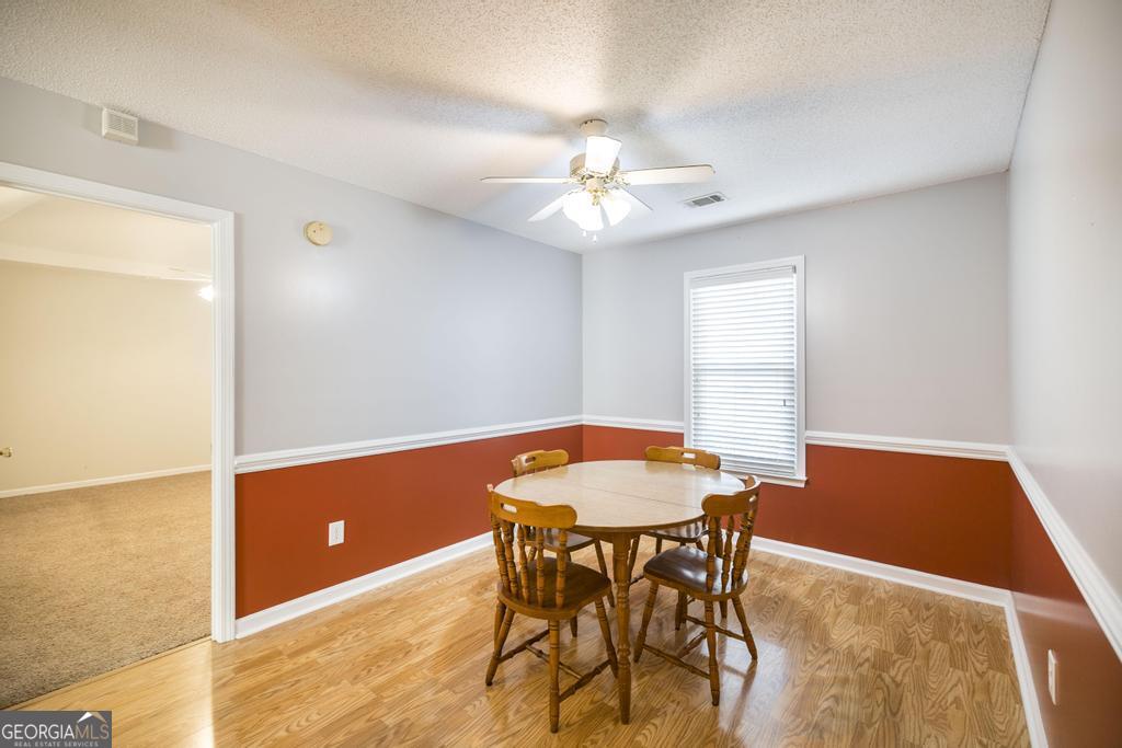 209 Mossy Ridge Warner Robins, GA 31088 - Photo 10 of 38 a view of a dining room with a table and chairs