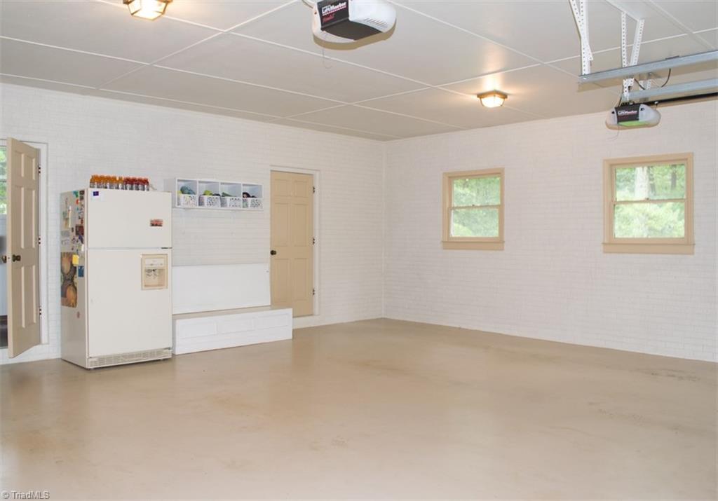 408 Brown Road King, NC 27021 - Photo 14 of 29 Two car attached garage, main house, with painted brick and painted concrete flooring