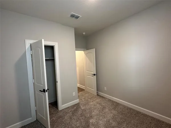 an empty room with closet area