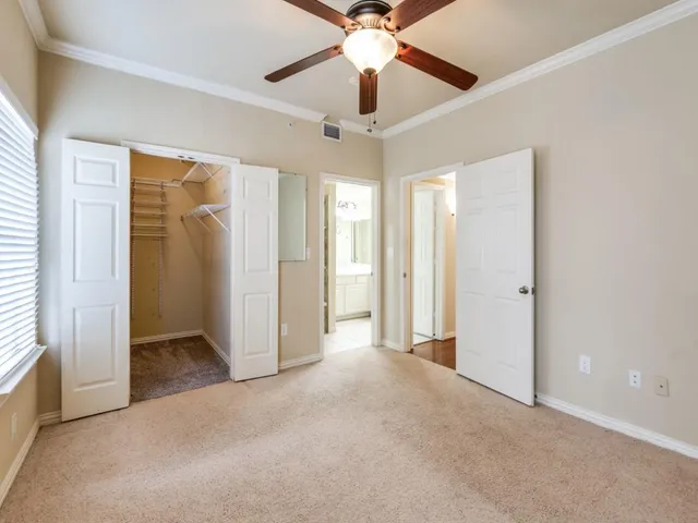 an empty room with fan and entrance